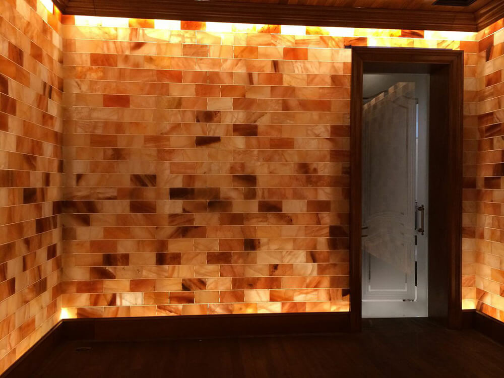 Backlit salt stone walls with a glass door at a private home in Westlake Village, California