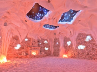 Saltana Cave. Large Salt Cave With Openings In The Ceiling Revealing White Lights Meant To Represent The Night Sky. In The Front Of The Cave Is A Stone Structure Built To Look Like A Fireplace.