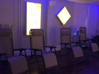 Alternative Healing Solutions Four lounge chairs in dim room with blue lighting behind them