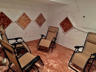 Anti Aging Center of Boca. Four lounge chairs In salt room. White walls with salt panels on them