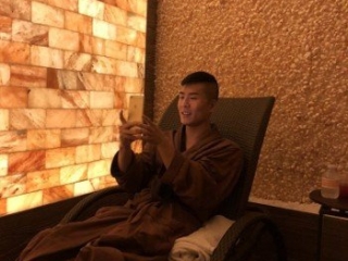 Caesars Entertainment. Man In Robe Relaxes In Lounge Chair Inside Of Spa Room.
