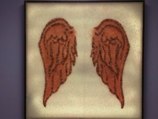 Spiritquest Healing Center. Image Mounted On Wall Made Of Salt And Stone In The Shape Of Wings.