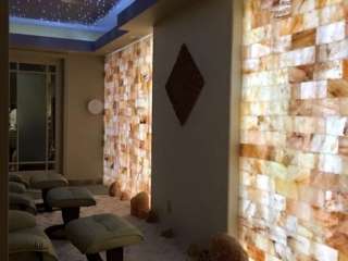 Kalahari Resort. Brown Lounge Chairs In Salt Room Facing Tiled Wall. The Ceiling Appears To Have Scattered Blue Lights To Resemble Stars.