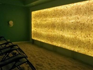 North Shore Salt Therapy Center. Three Lounge Chairs In Smaller Salt Room Facing Lit Up Salt Wall In A Movie Theater Fashion