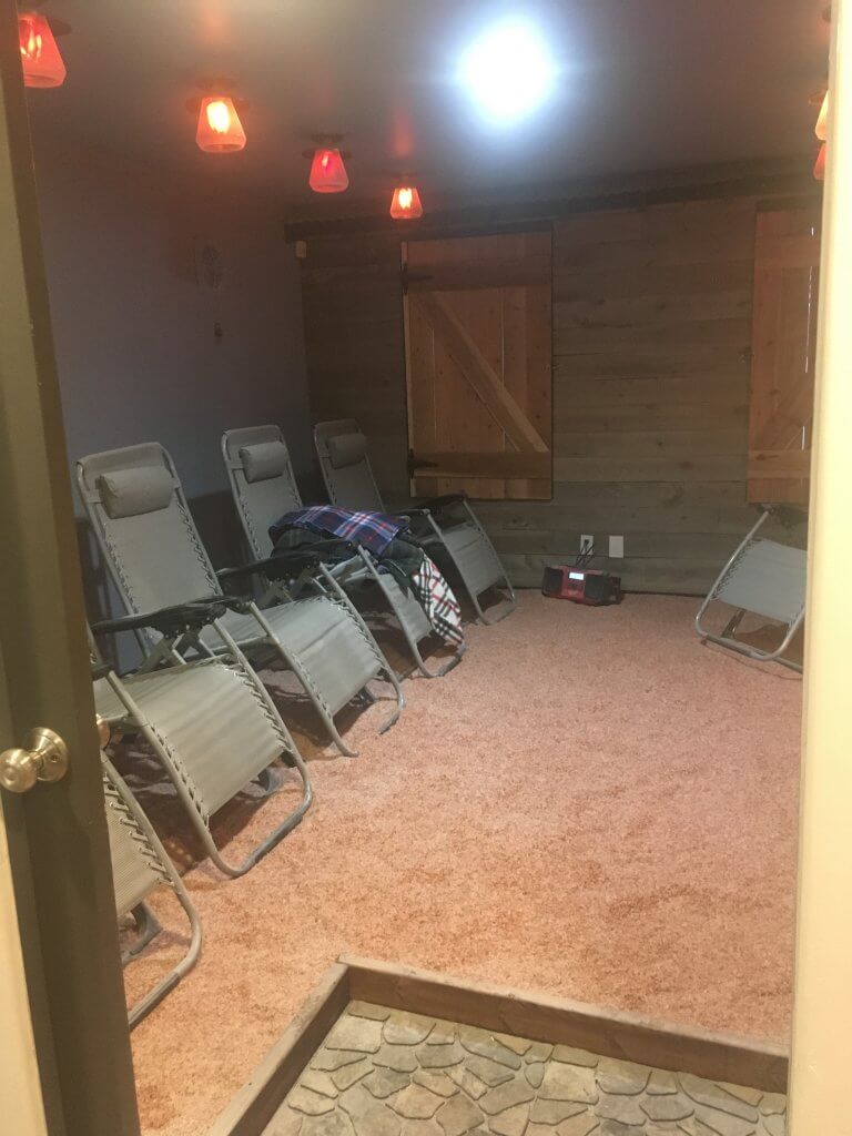Northern Altitude Southern Charm Salon. Salt room showing the lounge chairs as well as the fireplace
