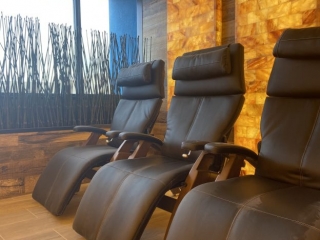 Optimum Building, Llc. Three Reclining Chairs Facing Tiled Wall. Window Behind The Chairs With Plants In Front Of Them.