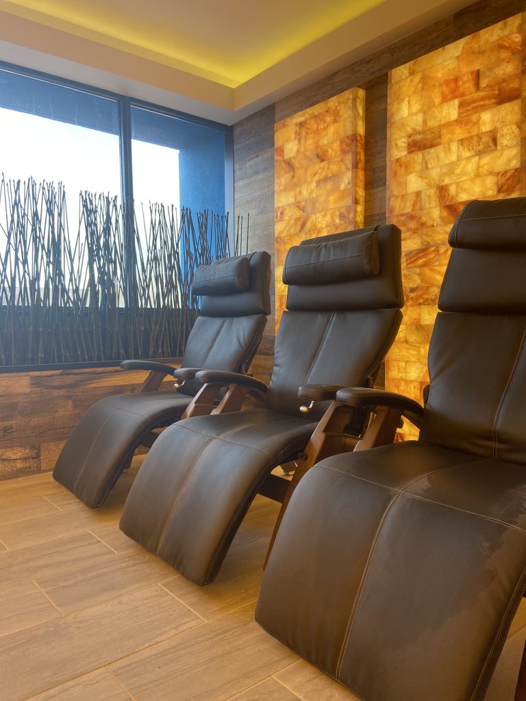 Optimum Building, LLC. Three reclining chairs facing tiled wall. Window behind the chairs with plants in front of them.
