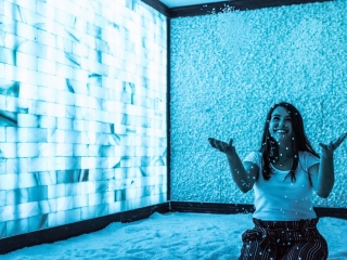Salt - A Halotherapy Spa Woman In Salt Room, Happily Tosses Salt Into The Air.