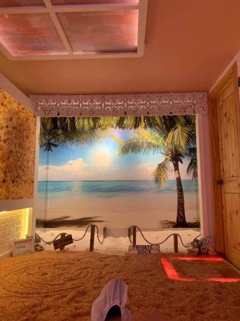 Salt Cove Wellness. View from laying in lounge chair facing image of the beach.