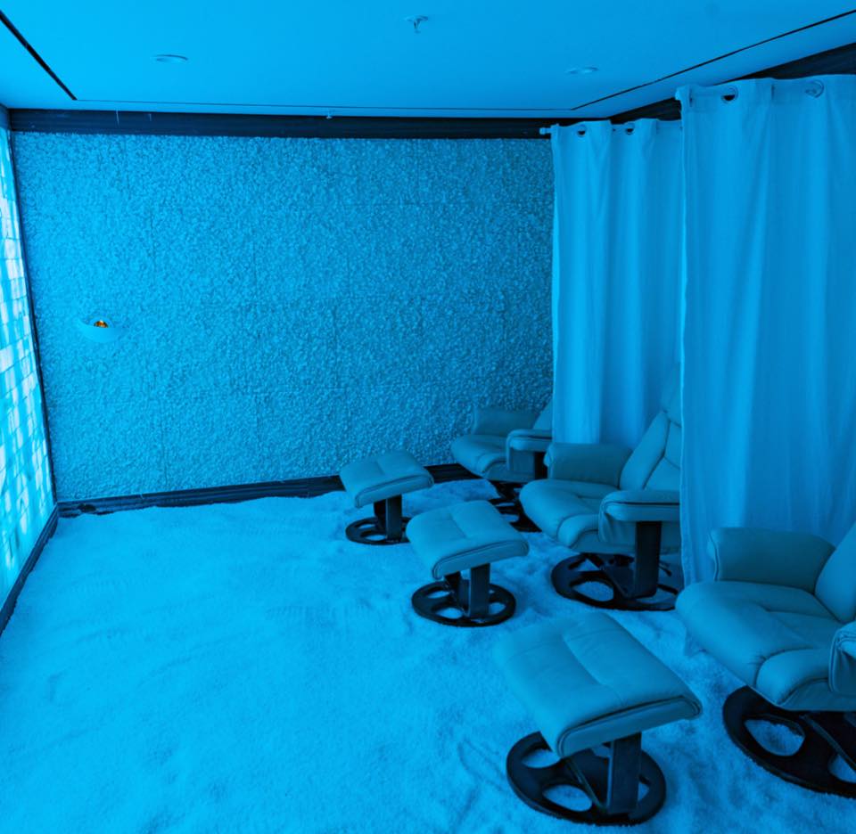 Salt...A Halotherapy Spa. View looking down on the same chairs, ottomans and curtains in the salt room.