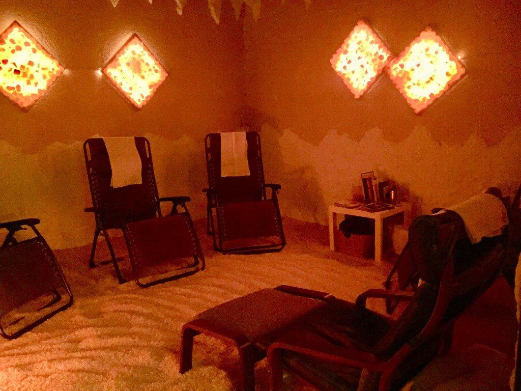Four Reclining Chairs And One Chaise On A Salt-Covered Floor With Four Diamond Himalayan Salt Stone Décors On The Walls At The Salt Studio - Pasadena, California.
