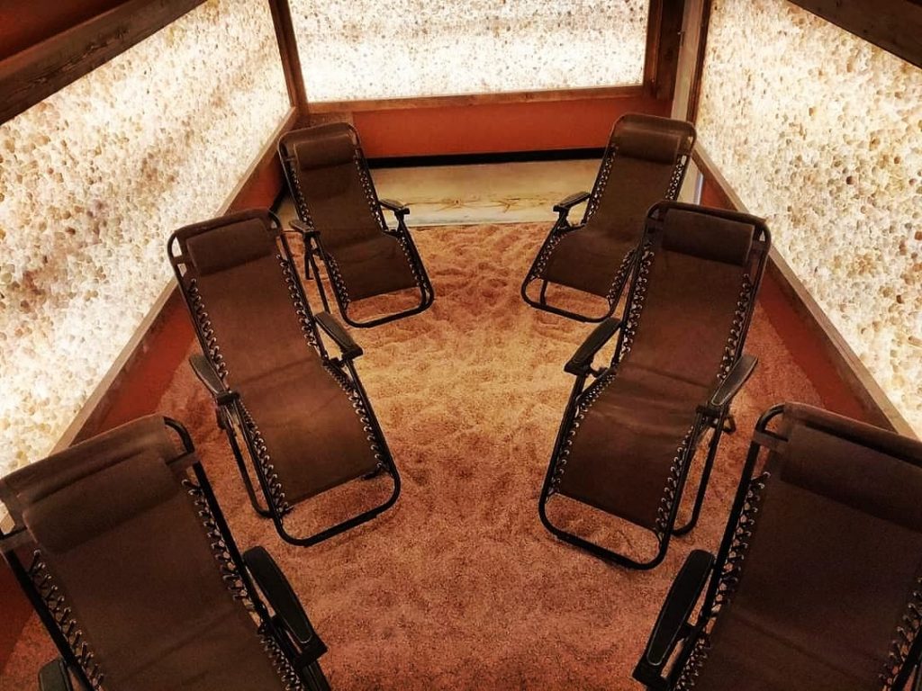 Trade Secrets Skincare. 6 Lounge Chairs Slightly Angled Inward All Facing Forward. Floor Is Completely Covered By Salt.