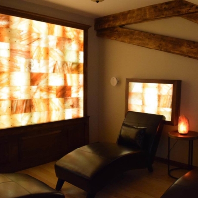 Salt Therapy Room With Three Black Lounge Chairs With Led Backlit Salt Panels At Verbena Holistic Center - Southington, Connecticut.