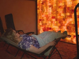Inspirit Salt Spa. Woman Laying Back, Reclined In A Lounge Chair In Spa Room.