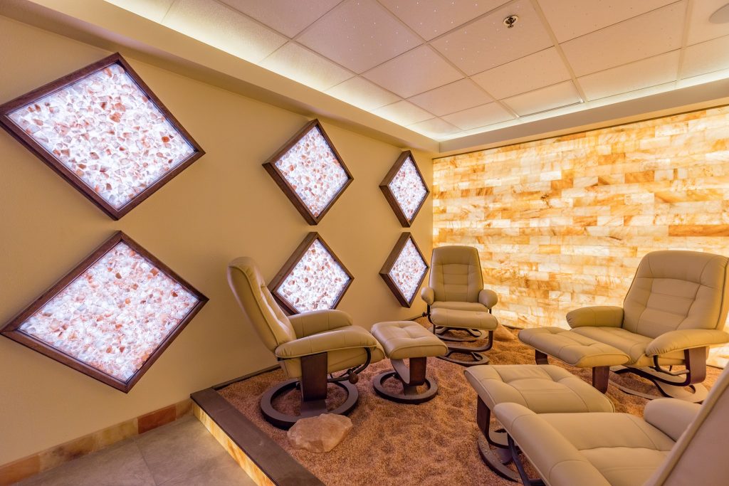 Kalahari Resort. Four brown lounge chairs facing each other inside salt room. 6 diamond shaped salt decorations are mounted on the wall.
