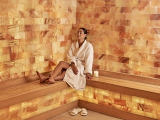 Jw Marriott Miami Turnberry Resort &Amp; Spa. Woman In Robe Is Relaxing On Bench Which Is Wrapped Around The Spa Room.