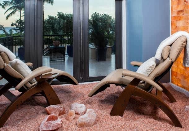 nSpa Delray Beach Marriott. Two lounge chairs sitting in pink salt rocks, facing the outside view of Delray Beach.