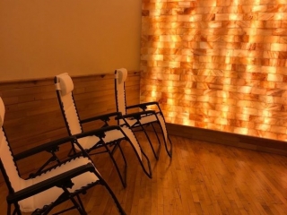The Salt Barre. Three Lounge Chairs In Spa Room Face Salt Tiled Wall.