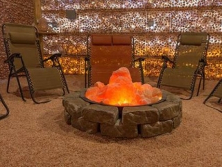 Pellegrino Healing Center. 6 Lounge Chairs Wrapping Around Stones Which Built To Look Like A Fire Pit. Glowing Salt Rocks On Top Of The Stones Are Meant To Represent Fire.