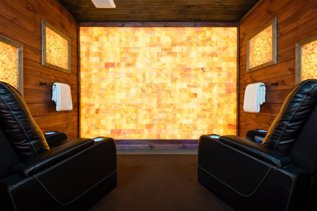 LaRose Muscular Therapy. Two large black massage chairs sit in spa room while facing tiled wall.