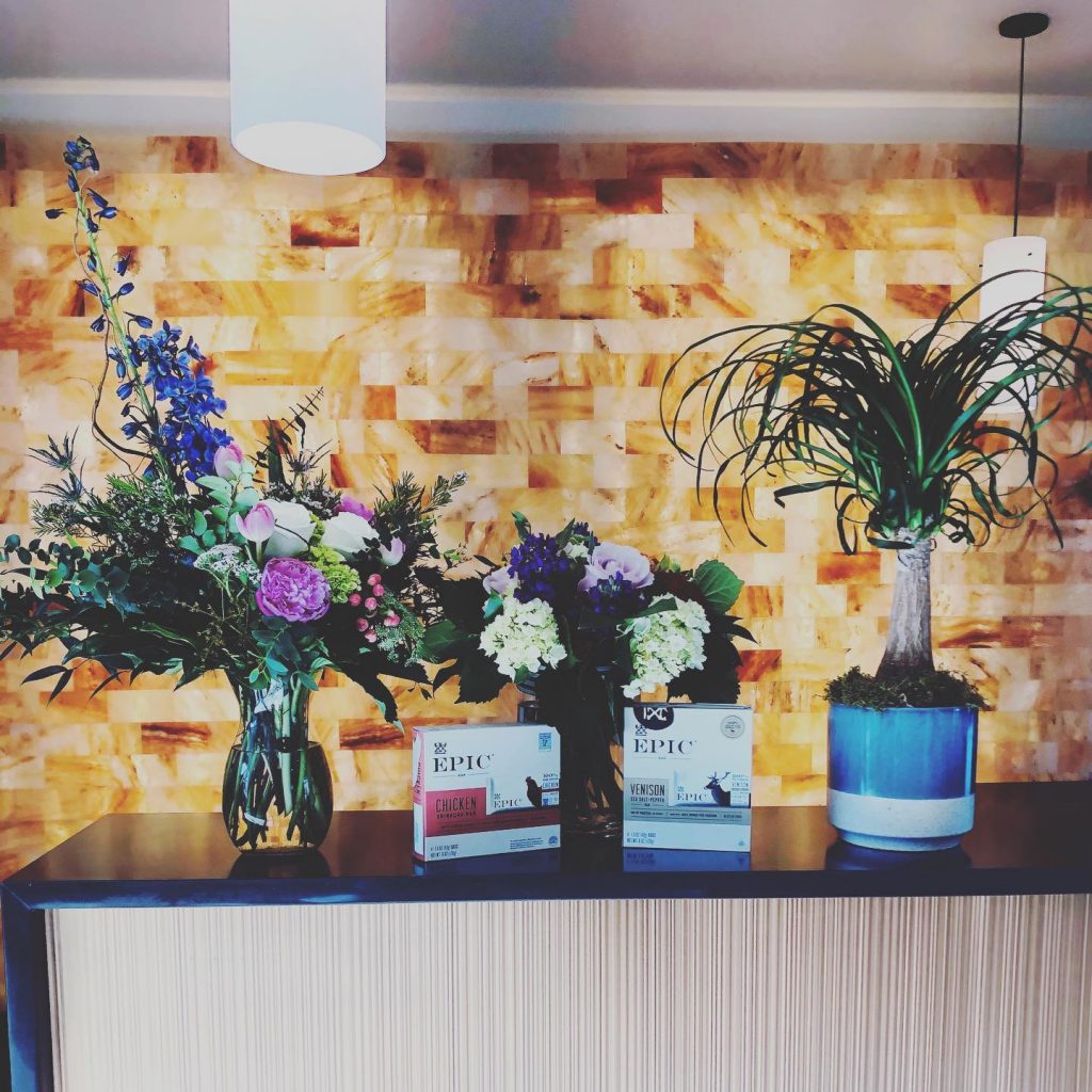 SALT Health. Front desk with plants on the counter.
