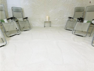 A White Salt-Covered Floor With White Salt Walls And Four Reclining Chairs At The Fusion Therapy In Sarasota, Florida