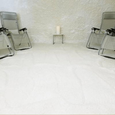 A White Salt-Covered Floor With White Salt Walls And Four Reclining Chairs At The Fusion Therapy In Sarasota, Florida