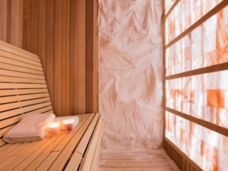 Ohh Yeah Fitness Complex. Small, Sauna Like, Salt Room. Candles Lit On Bench With Two Towels Ready To Be Used.