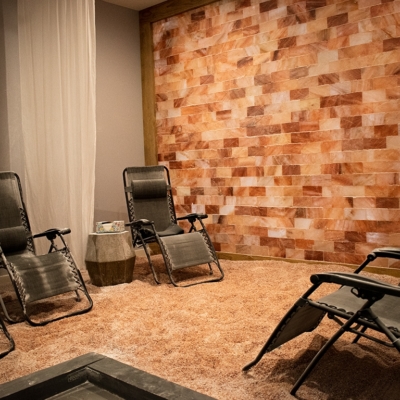 Lounge Chairs Facing Each Other In A Room With A Pink Salt Wall And Pink Salt On The Floor At Kersenbrock Medical And Wellness In Lake Mary, Florida