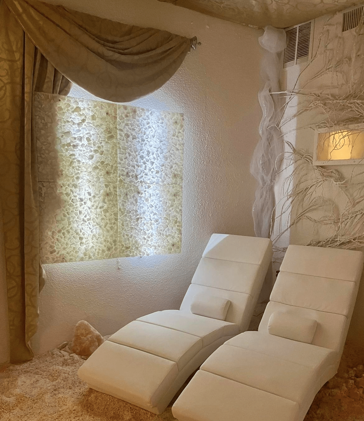 The Salt Room At 811 Salt &Amp; Vine In Flagler Beach, Florida With Two Chairs And Custom Himalayan Salt Panels On The Wall.