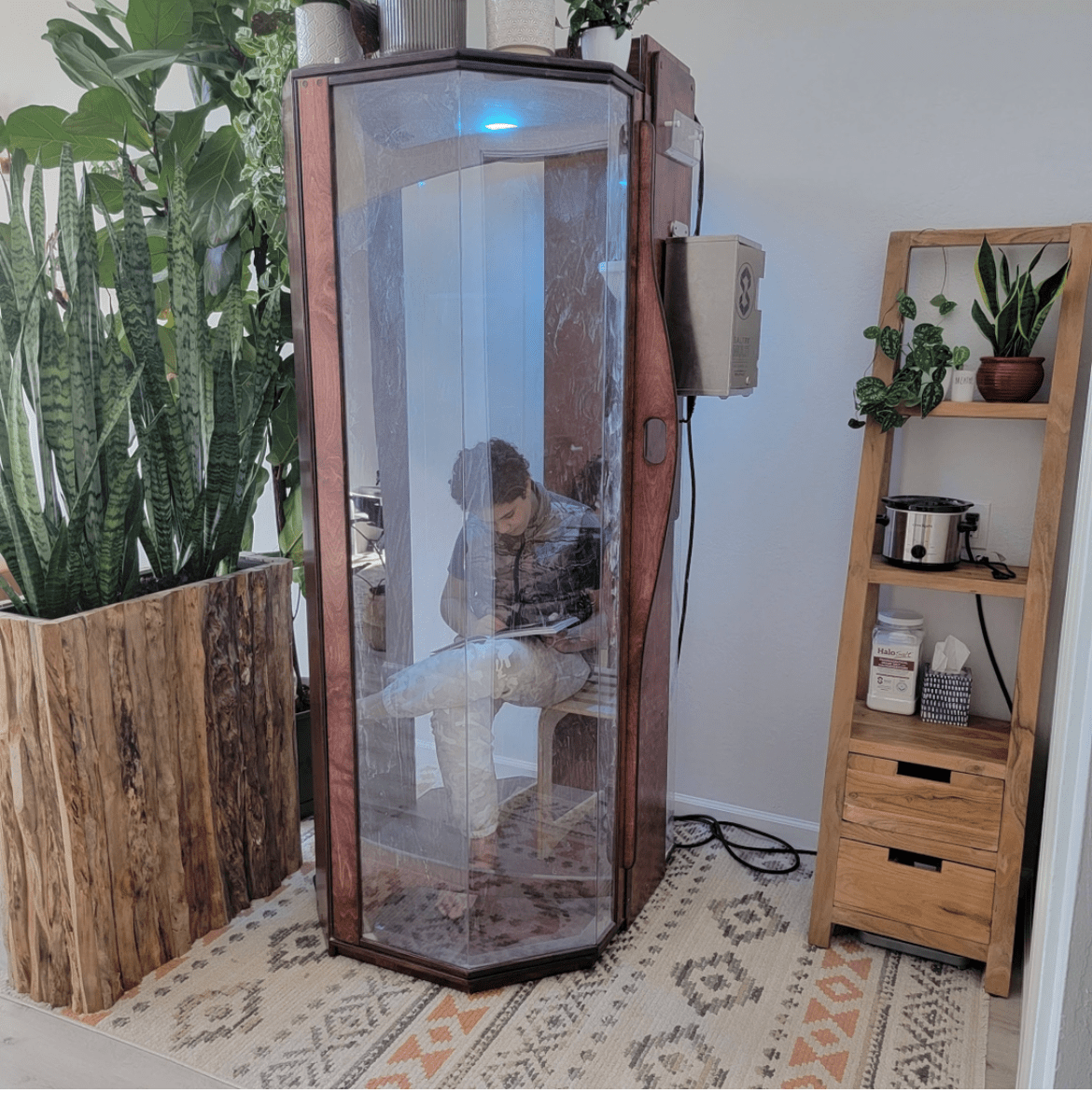 A customer using the Original SALT Booth for a salt therapy session at Bay Area Brain Spa in Albany, California.