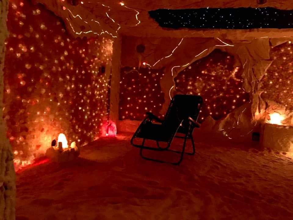 BellaVita Salt Caves. Extravagant salt cave with scattered lights and a single lounge chair in the center.