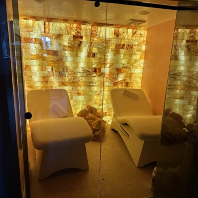 A Salt Room At A Private Home Residence With Two Lounge Chairs And A Himalayan Salt Brick Wall.