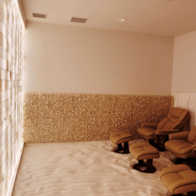 Eleventh Element. Bright Salt Room. White Salt On Floor With Lounge Chairs Facing Stone Wall.