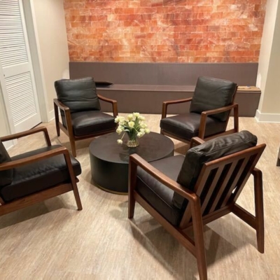 Four Chairs, A Table, A Long Bench And A Himalayan Salt Brick Wall.