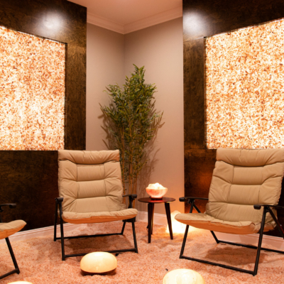 The Salt Room At Inspire Dry Salt Therapy In Florence, Alabama With Three Chairs And Custom Himalayan Salt Panels On The Walls For Décor.