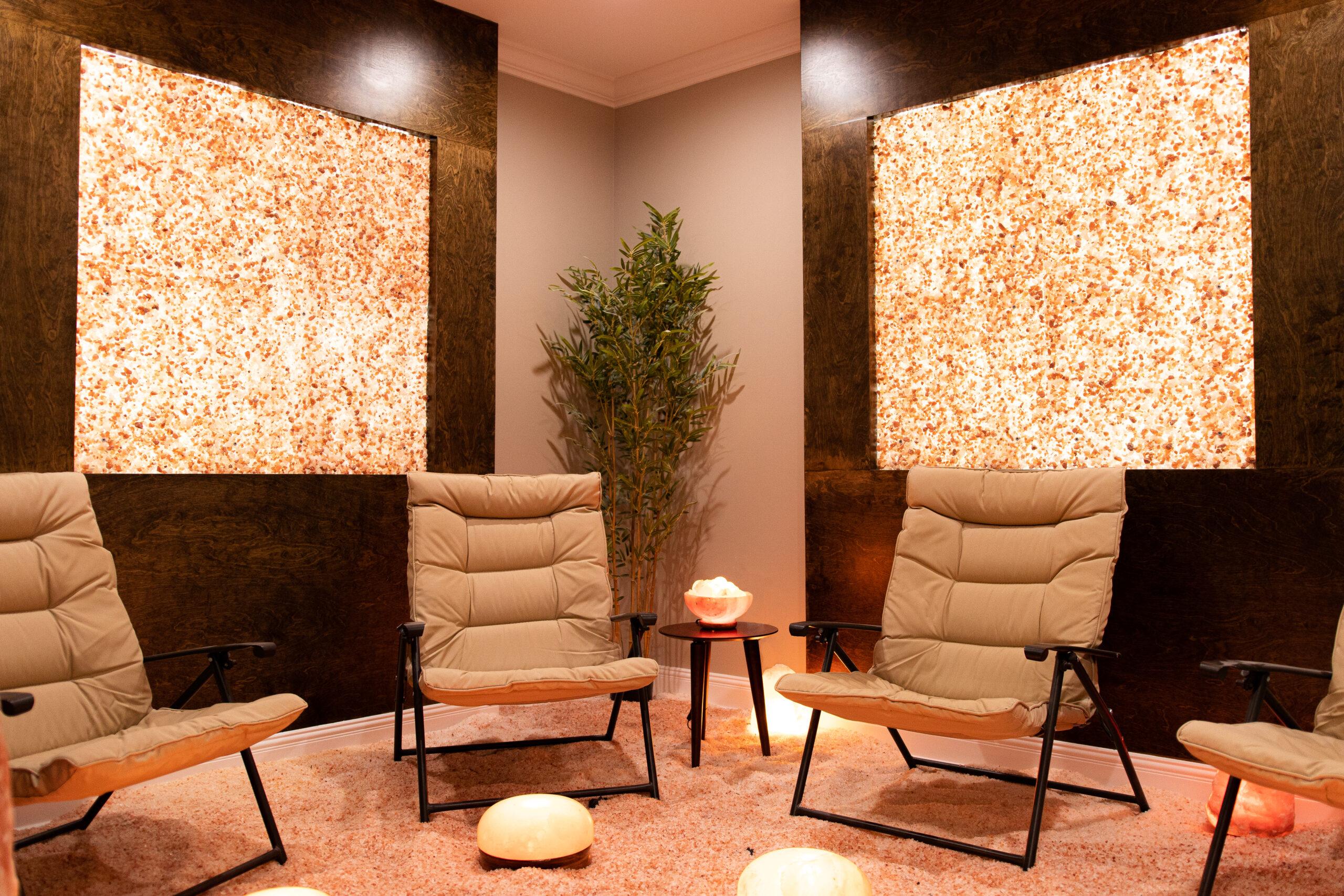 The Salt Room At Inspire Dry Salt Therapy In Florence, Alabama With Three Chairs And Custom Himalayan Salt Panels On The Walls For Décor.