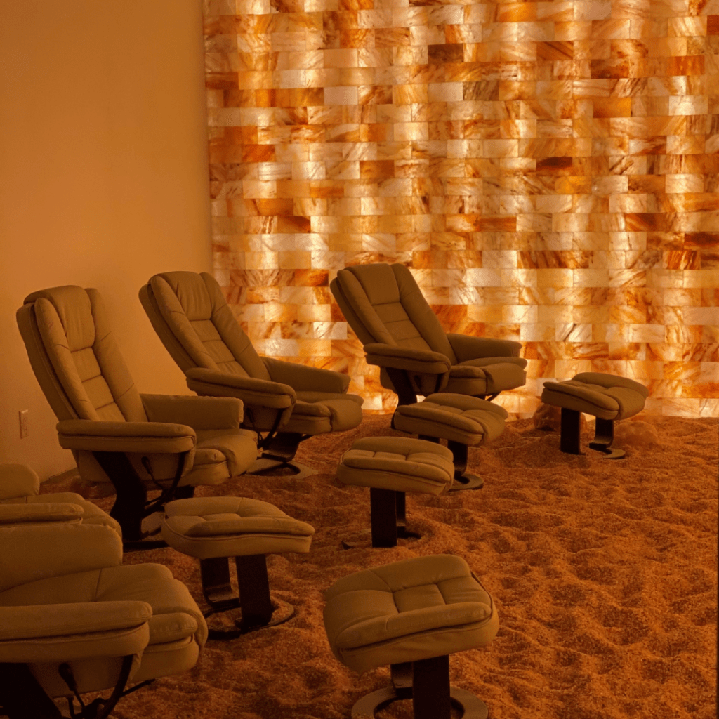 Kalahari Resort. 5 brown lounge chairs in salt room with views of salt rocks wrapped around the room.