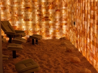 Kalahari Resort. 5 Brown Lounge Chairs In Salt Room With Views Of Salt Rocks Wrapped Around The Room.