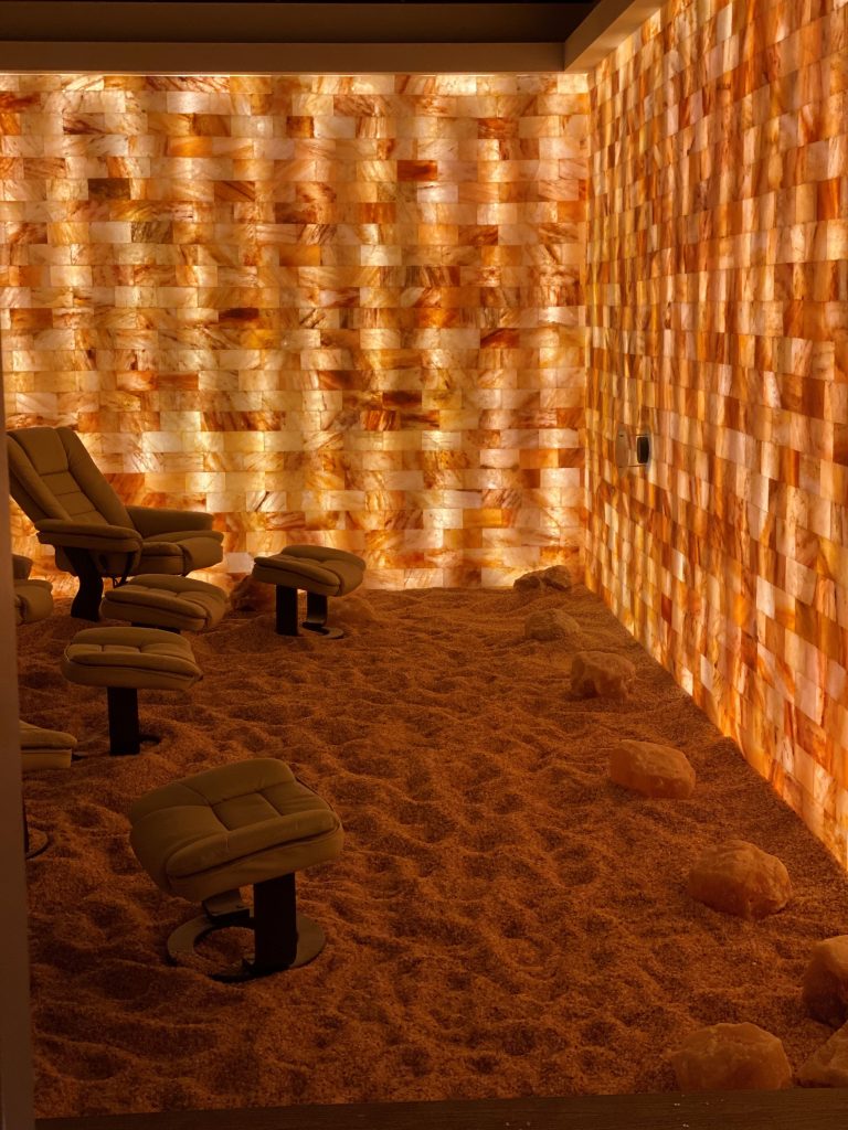 Kalahari Resort. 5 brown lounge chairs in salt room with views of salt rocks wrapped around the room.