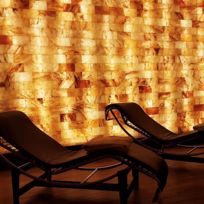 The Salt Room At Mirror Lake Inn Resort &Amp; Spa In Lake Placid, New York With Two Lounge Chairs And A Himalayan Salt Brick Wall.