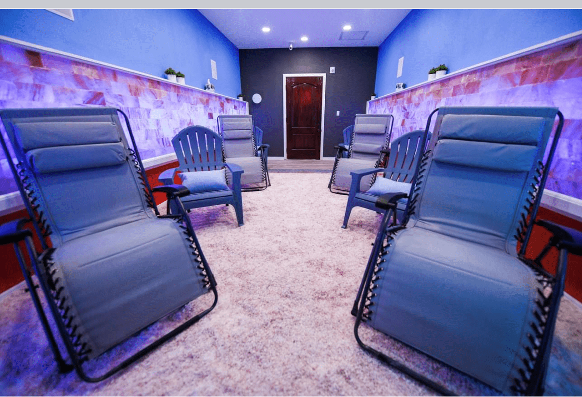 The Salt Room At My Sanctuary Of Wellness In Sarasota, Florida With 6 Chairs And Himalayan Salt Bricks On The Walls.