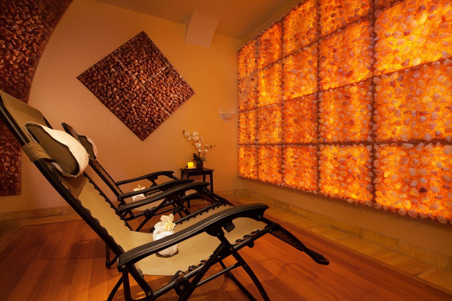 A Salt Room With Two Chairs And Himalayan Salt Panels On The Walls