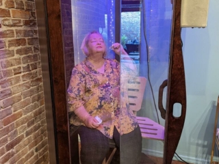 A Woman Sitting In A Salt Booth For A Salt Therapy Session At Solace Wellness Studio In Boston, Georgia.