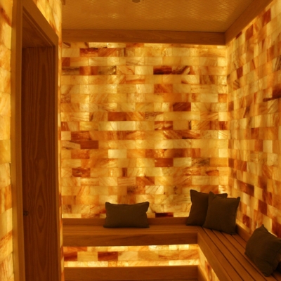 The Salt Room At The Ritz-Carlton In Charlotte, North Carolina With Benches, Pillows, And Himalayan Salt Bricks On The Walls.