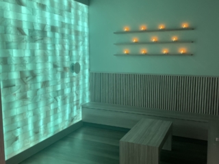 A Salt Therapy Room With A Himalayan Salt Brick Wall And Benches To Sit And Relax