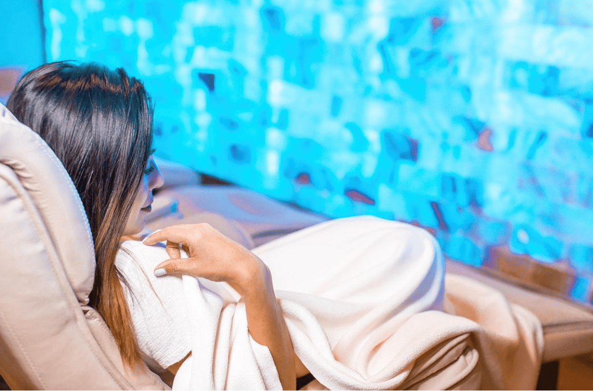 Woman Sitting In A Lounge Chair In A Salt Room Getting A Massage