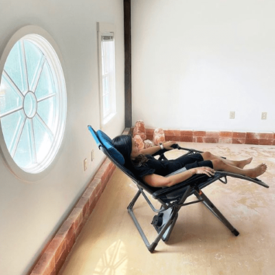 A Woman Reclining In A Chair Enjoying The Respiratory Benefits Of Salt Therapy In A Salt Room.