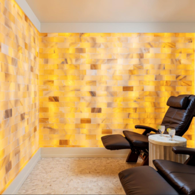 Two Recliner Chairs In A Salt Room With A Himalayan Salt Brick Wall At Watercrest Macon Assisted Living And Memory Care In Macon, Georgia