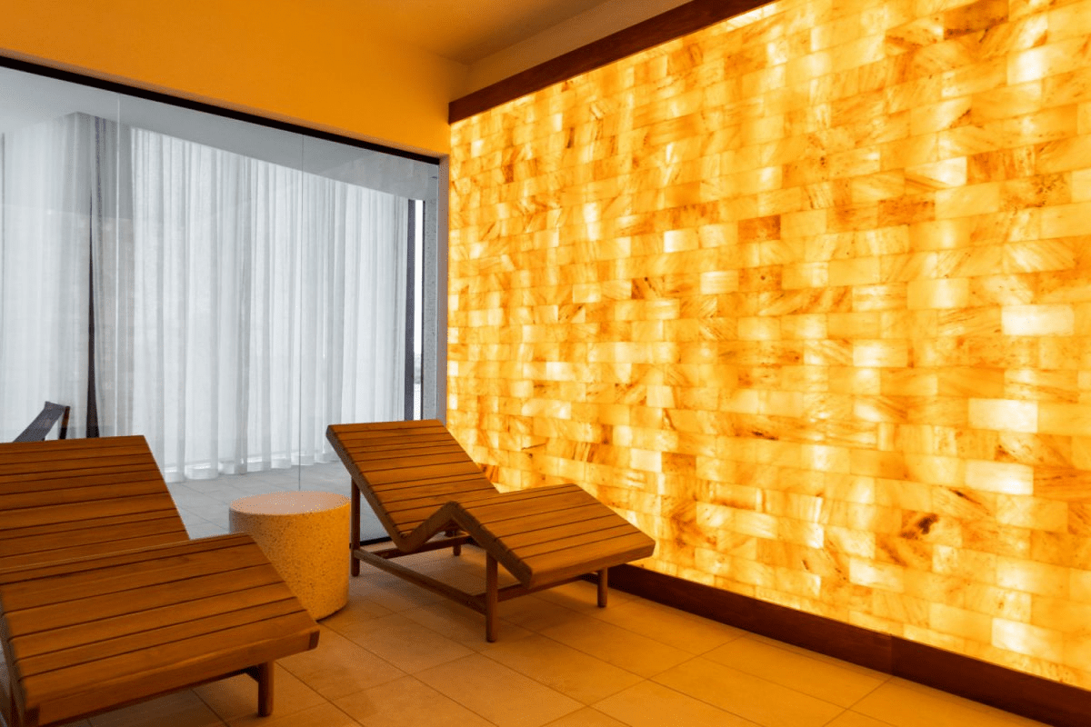 Two Recliner Chairs In A Salt Room With A Himalayan Salt Brick Wall At Gio Midtown In Miami, Florida